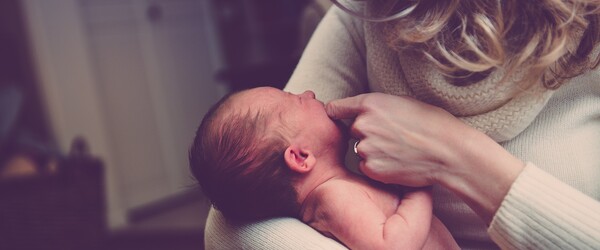 mother holding baby